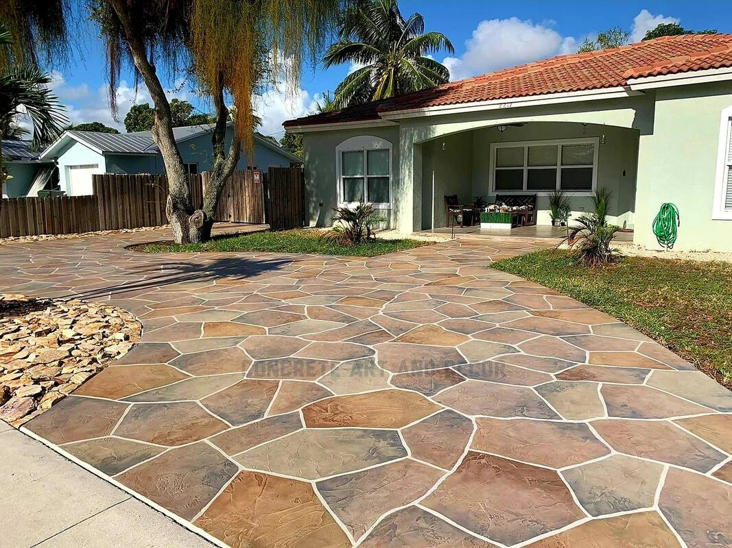 Stamped concrete in Leawood KS featuring decorative flagstone pattern with earth-tone color variations for driveway.